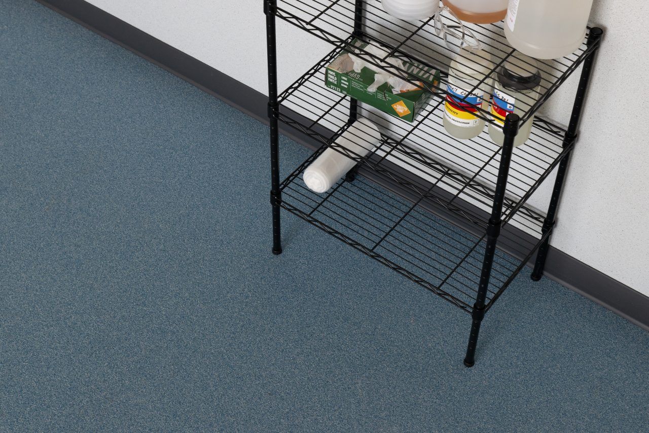Blue resinous quartz floor coating in a lab or storage area