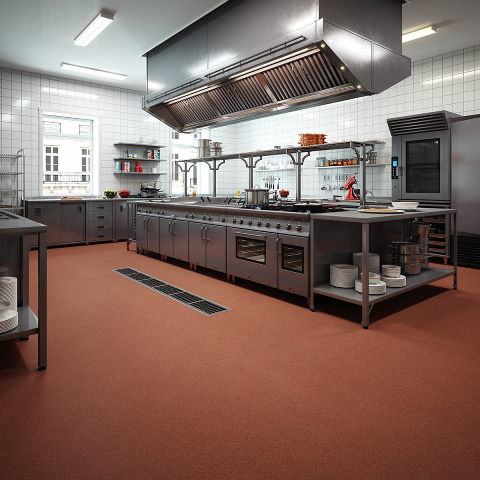 Commercial kitchen with a reddish quartz resinous floor coating