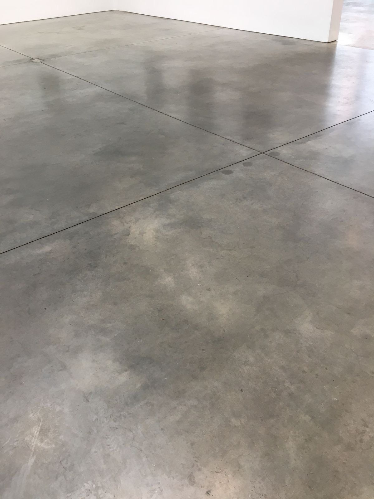 Smooth gray concrete floor finished with a clear protective sealer
