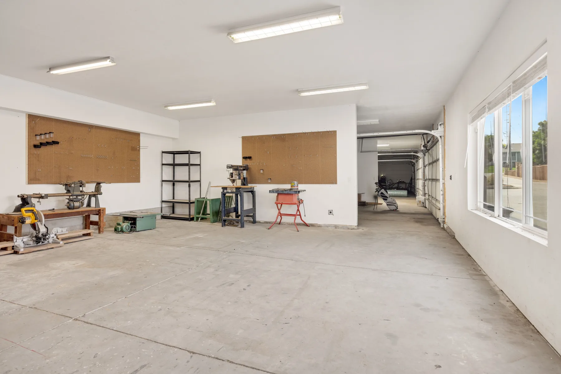 Bare, unfinished concrete floor in a bright work space before a coating is applied