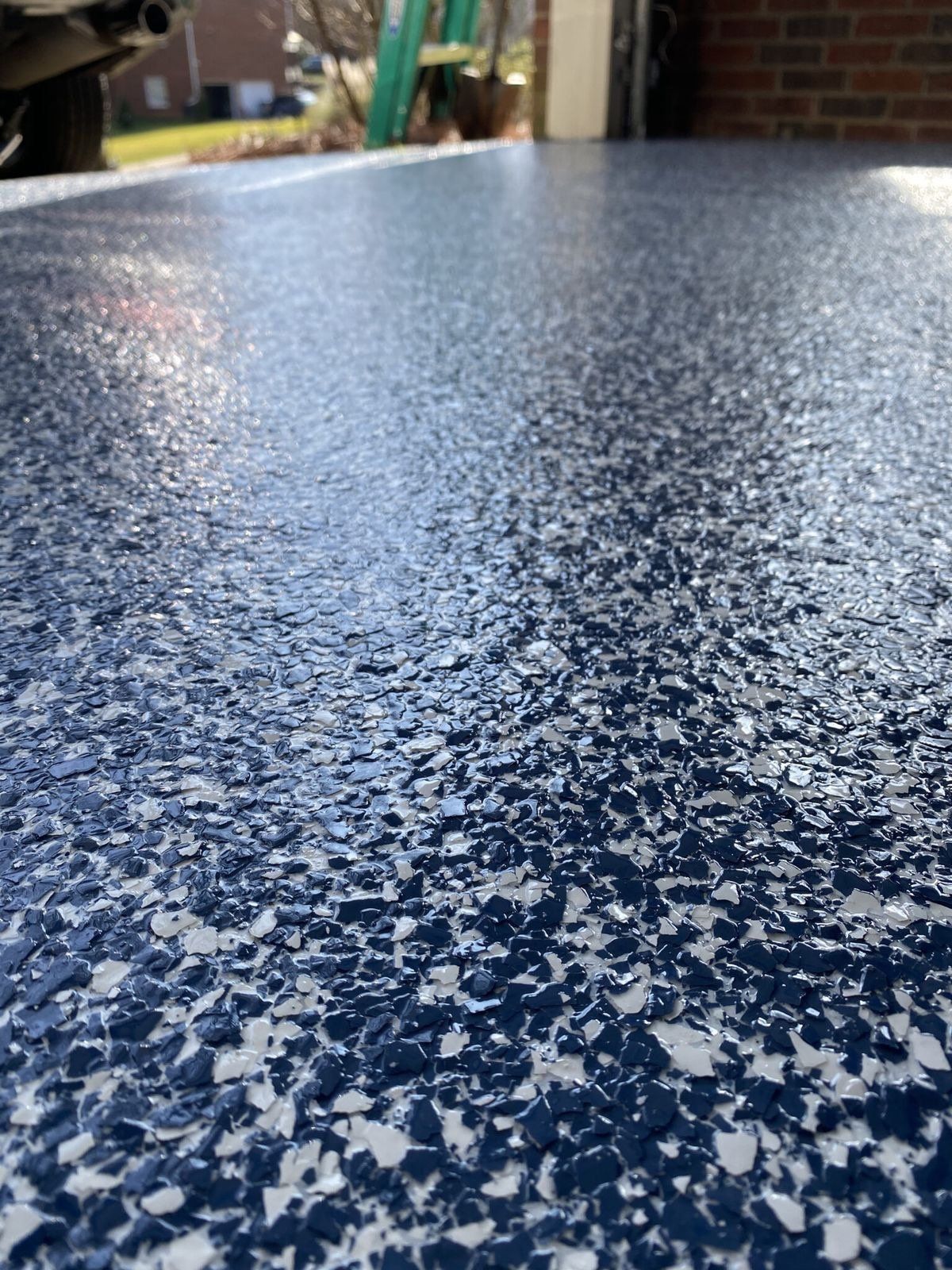 Blue, white, and gray flake epoxy garage floor with a glossy finish