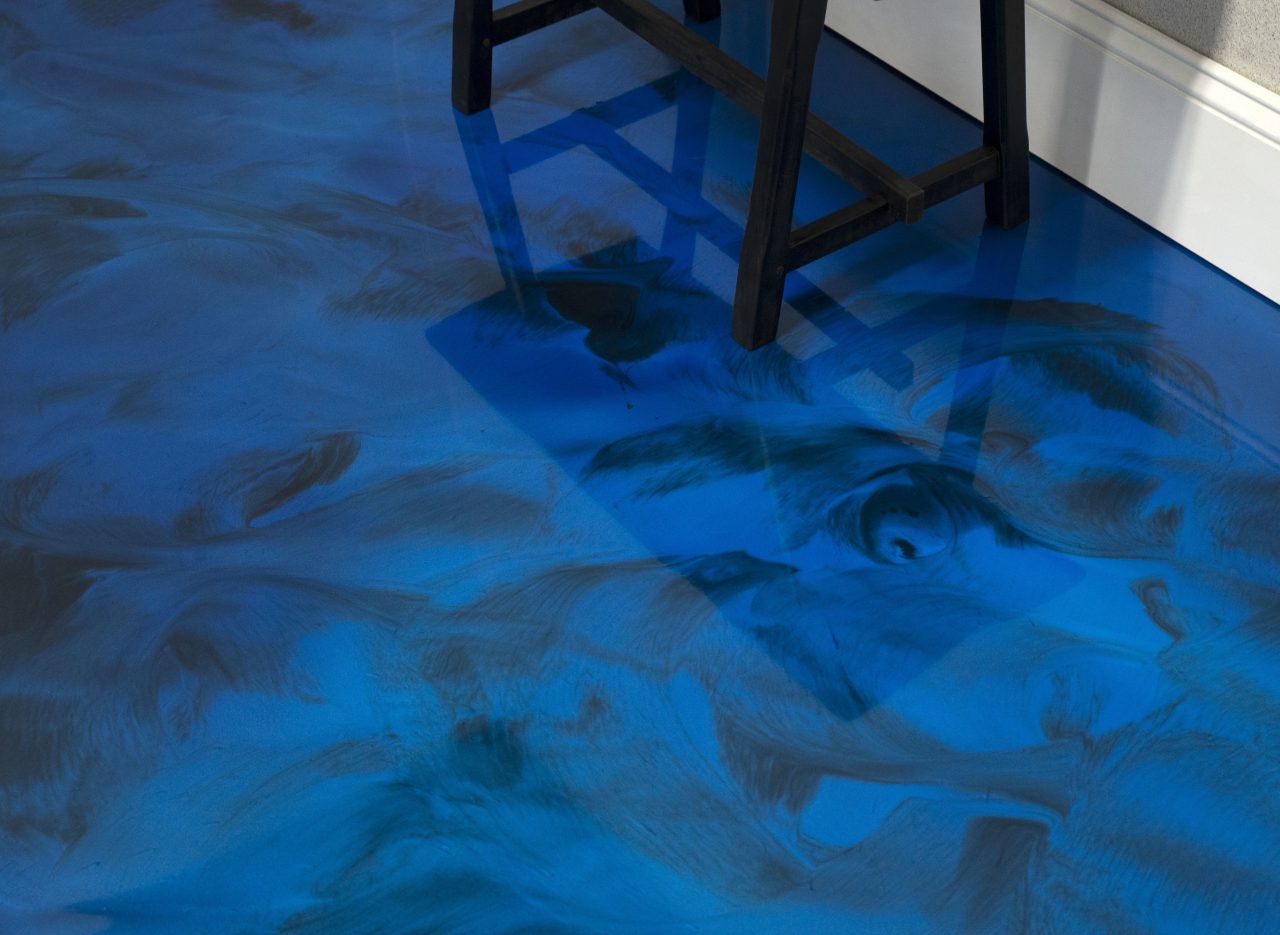 Glossy blue metallic epoxy style floor with soft marbled movement