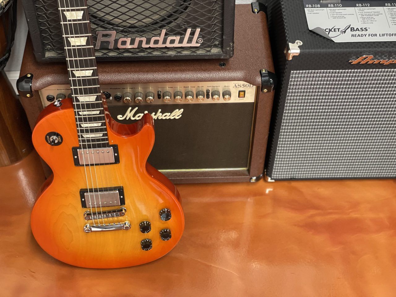 Warm orange metallic pigment floor coating in a music room setting
